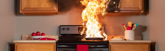 A grease fire flaring up from a frying pan. 